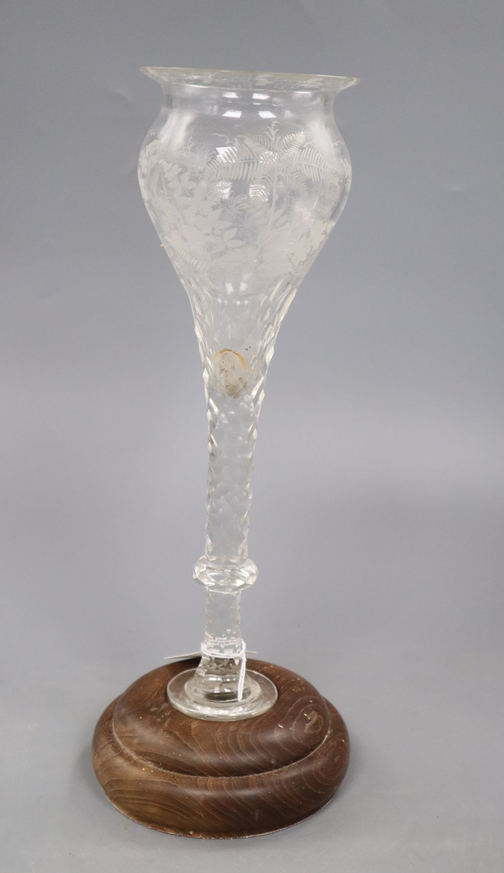 A facet cut glass vase on wooden base, total height 37cm